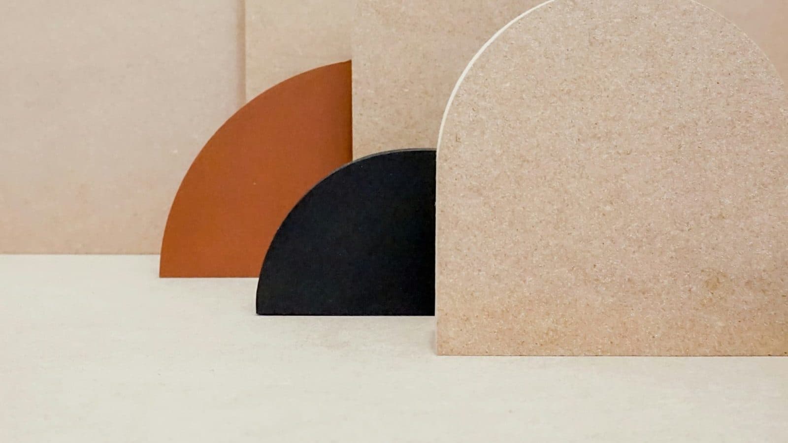Soft plaster arches in terracotta, black and sand